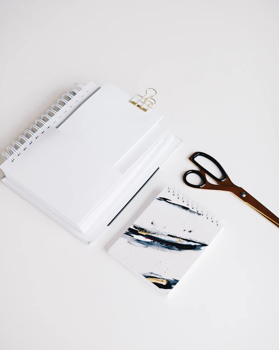 Colorful school supplies neatly arranged on a wooden desk.