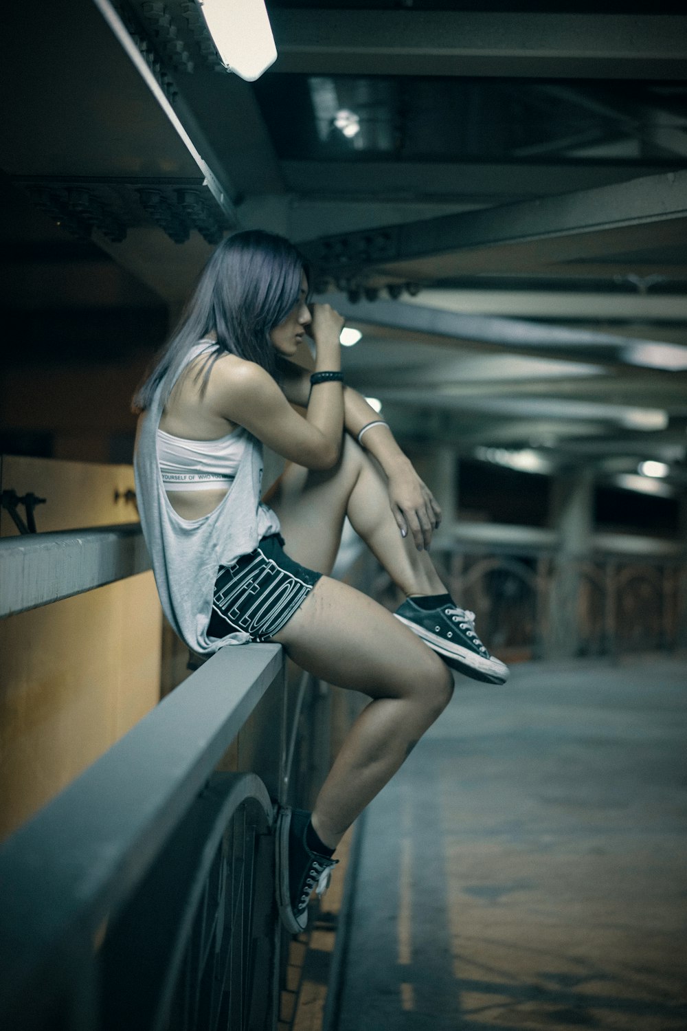 woman sitting on railing