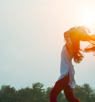 woman spreading hair at during sunset