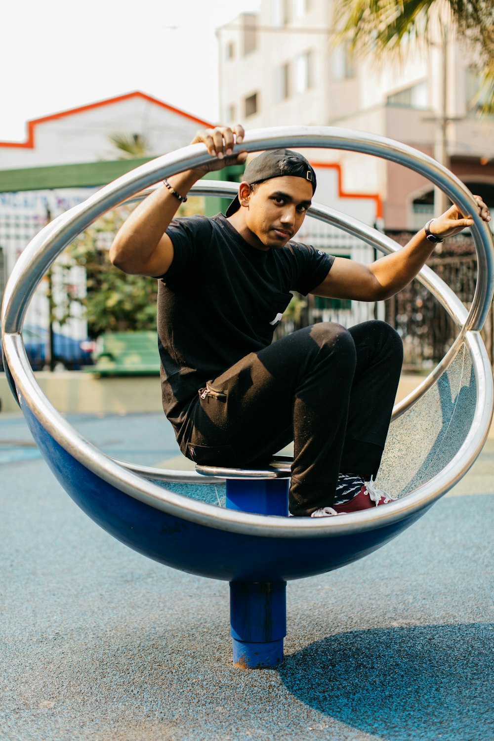 man sitting on blue and silver steel chair during daytime