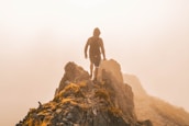 man standing on hill taken at daytime