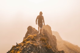 man standing on hill taken at daytime