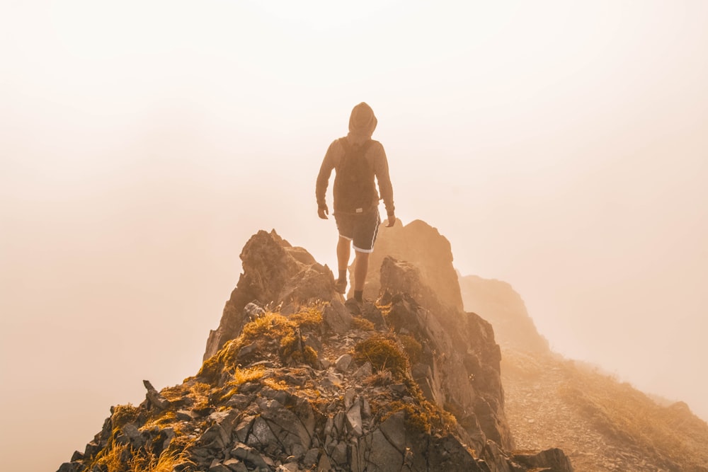 man standing on hill taken at daytime