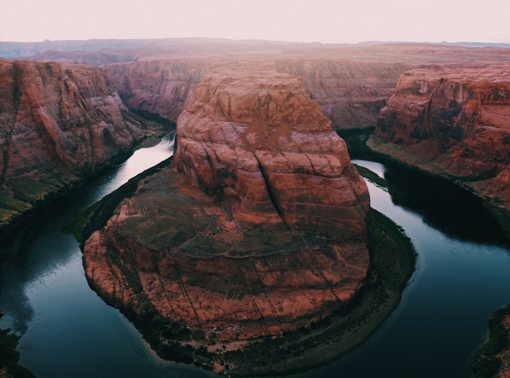 rock formation surrounded by body of water during daytime