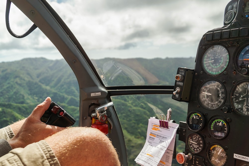 person driving helicopter from above