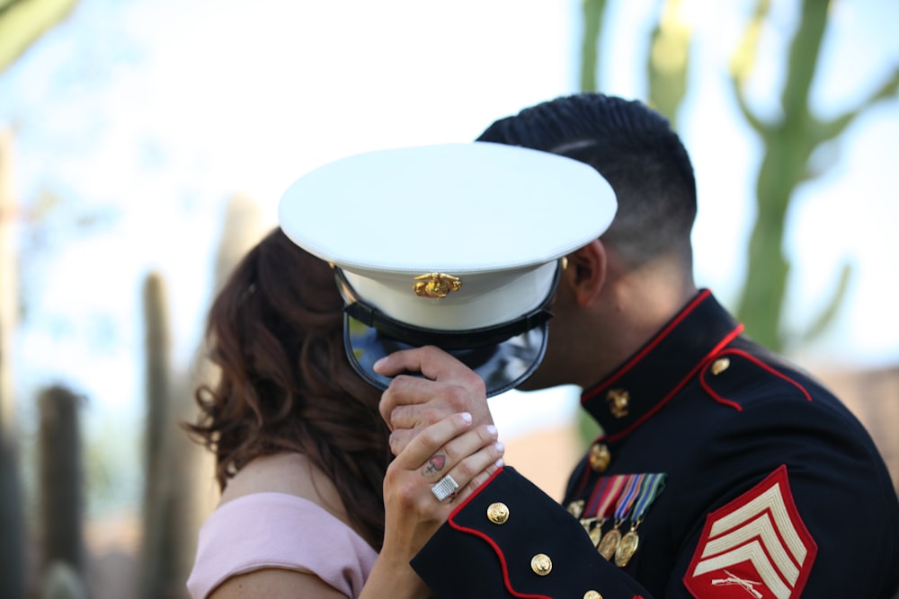 man covering his face with cap