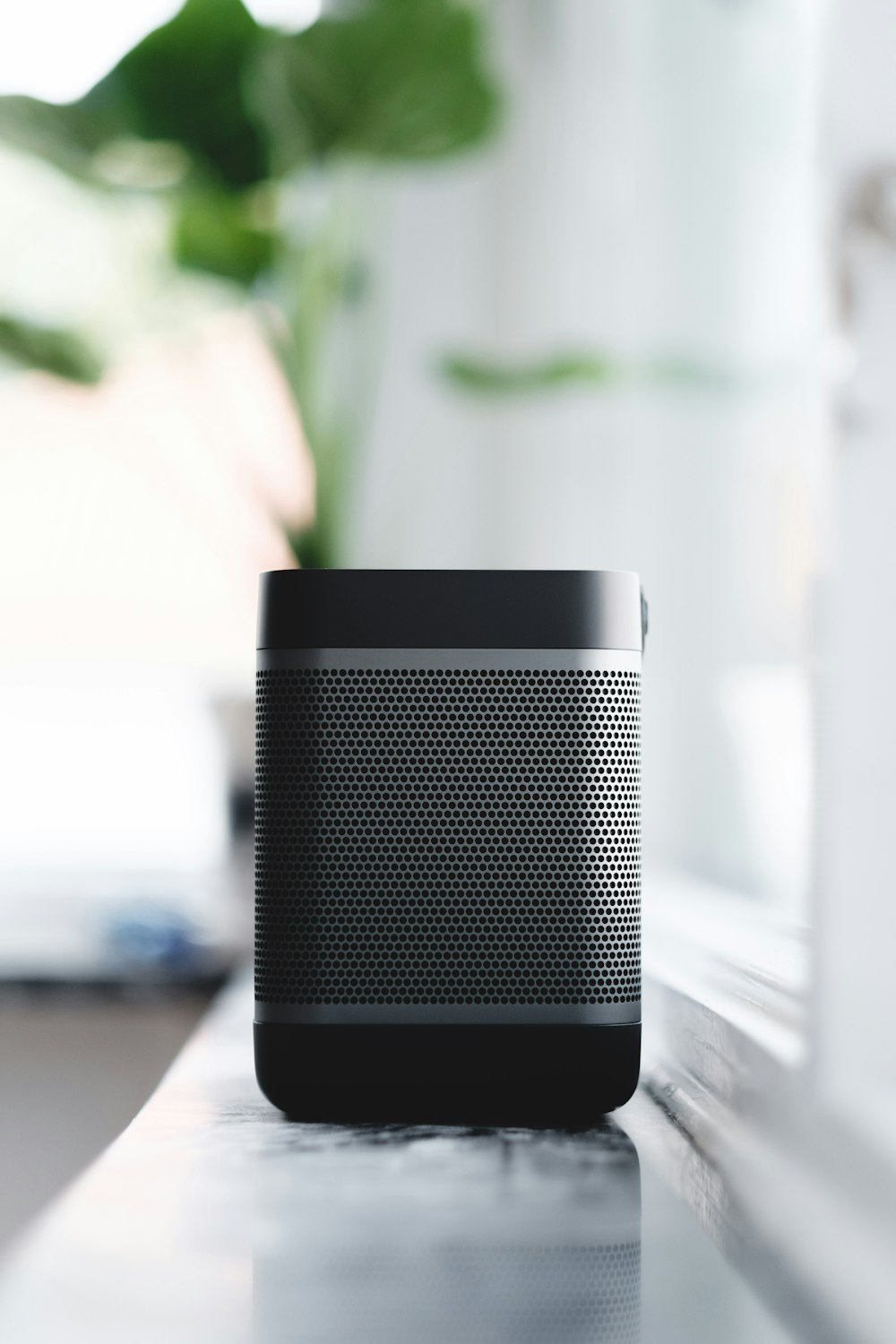 selective focus photography of black and gray portable speaker