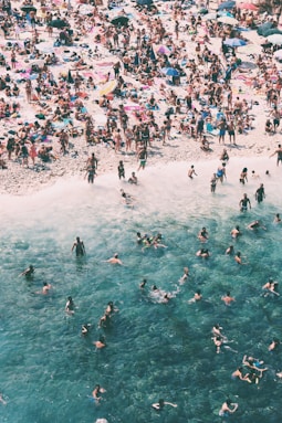crowded people gathered on beach