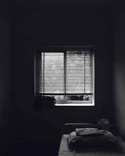 Quiet bedroom with large window and soft lighting