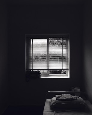 Quiet bedroom with large window and soft lighting