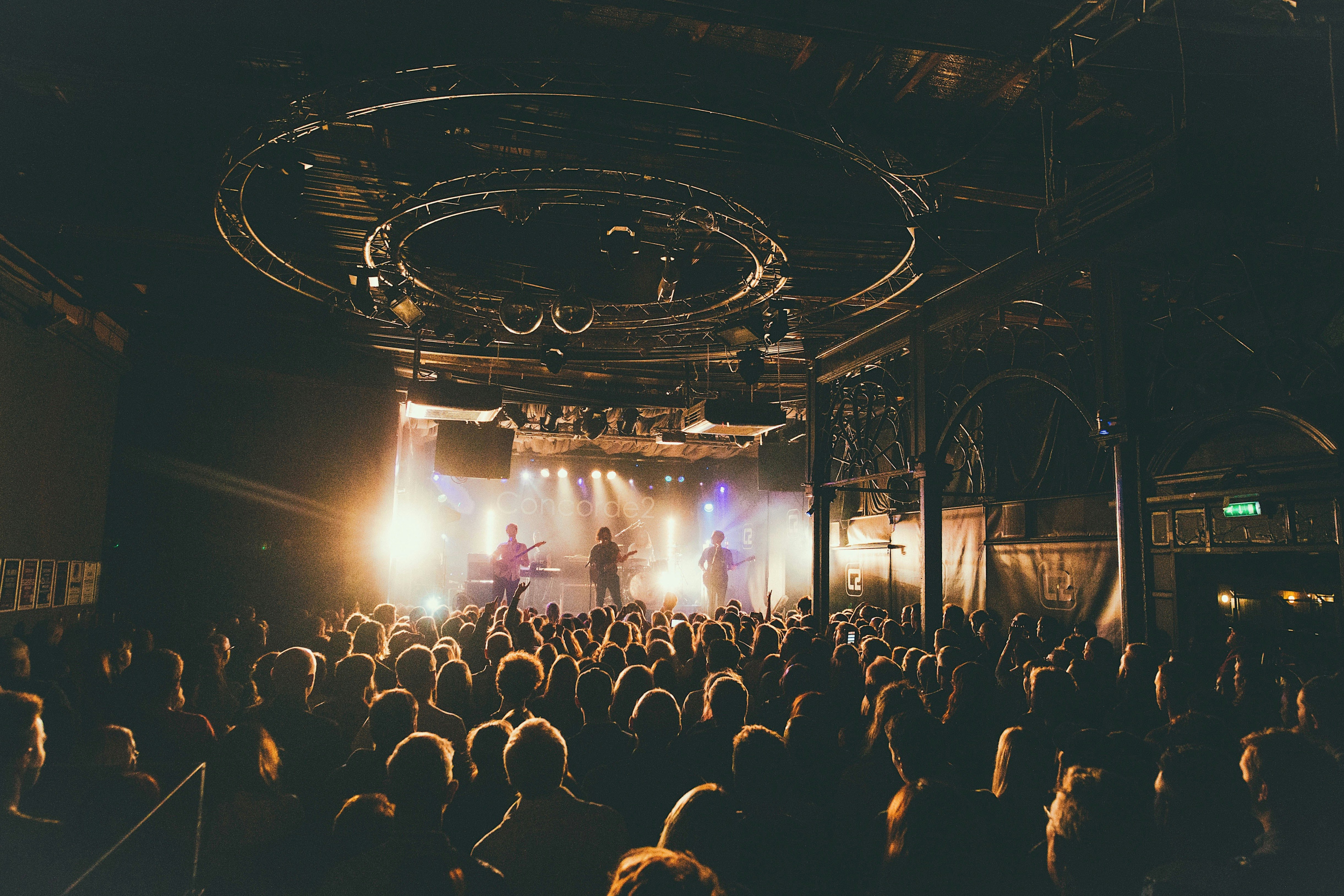 people attending concert inside dark room