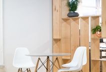 round glass-top table near shelf