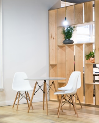 round glass-top table near shelf
