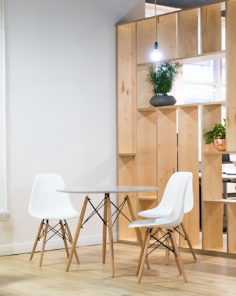 round glass-top table near shelf