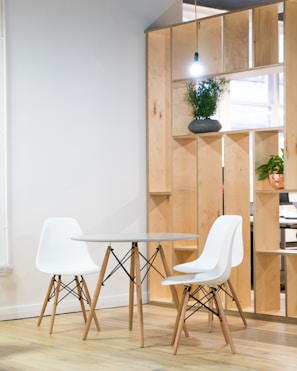 round glass-top table near shelf