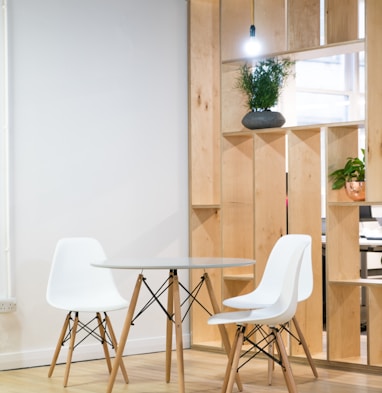 round glass-top table near shelf