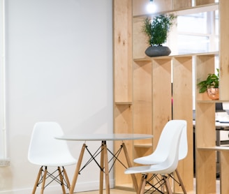 round glass-top table near shelf