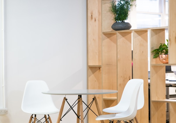 round glass-top table near shelf