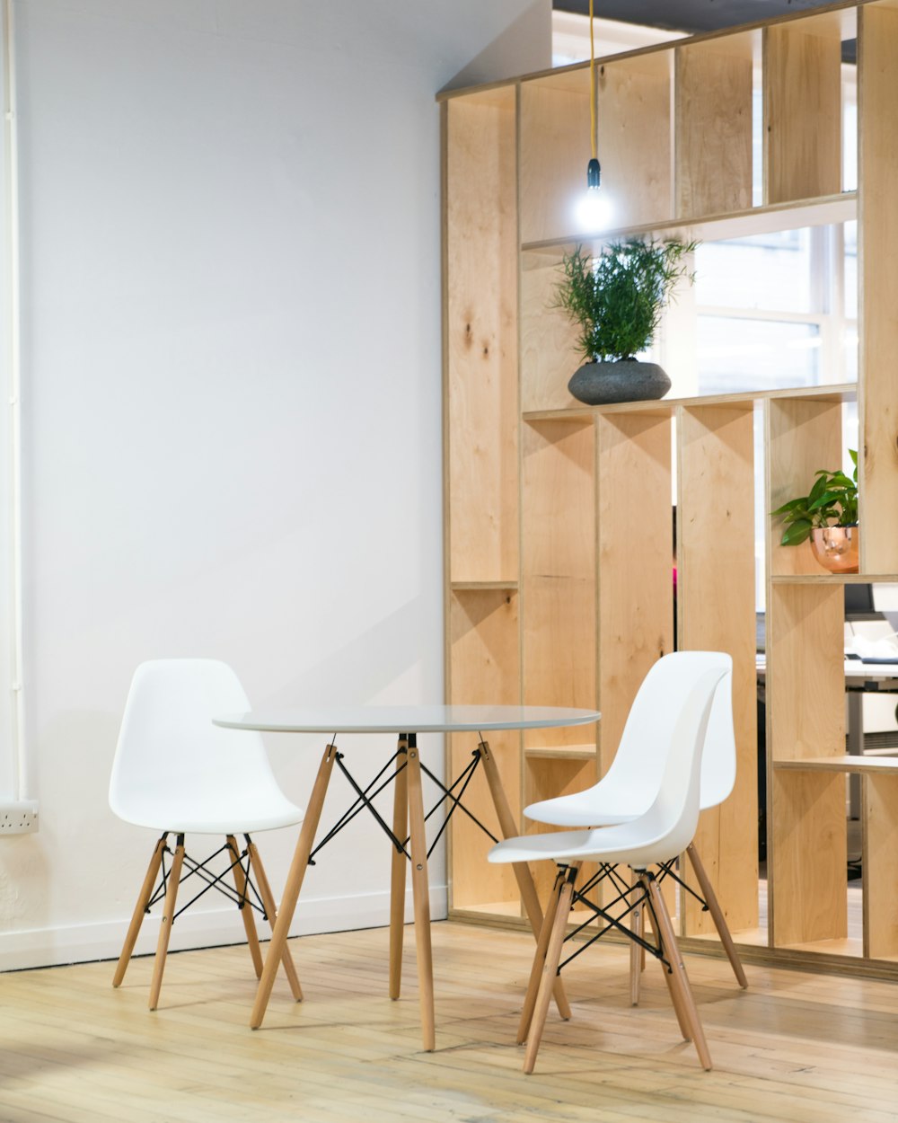 round glass-top table near shelf