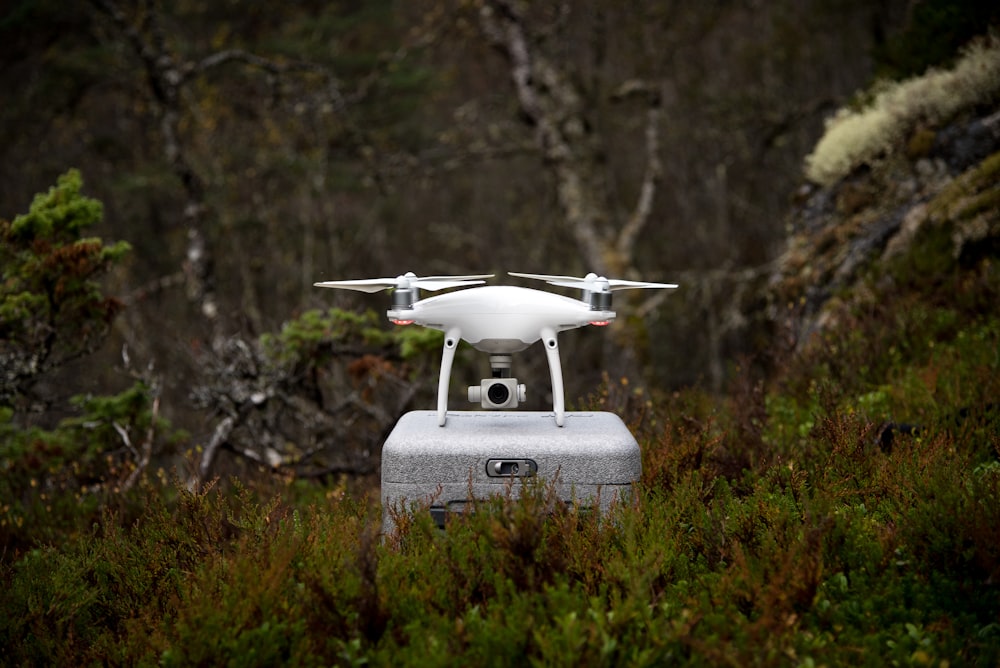 white and gray DJI Phantom drone on gray box