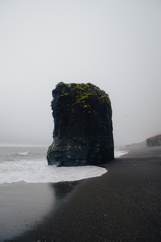 butte near body of water in Djúpivogur Iceland