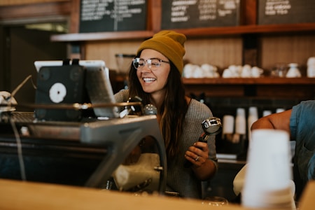 barista holding coffee filter for how to make money as an empath