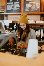 A happy business owner enjoying coffee while AI handles tasks in the background.