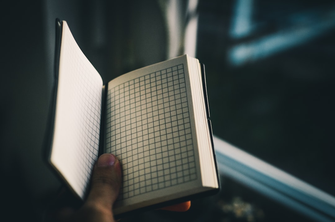 person showing a white page book