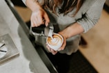 person pouring cup of coffee in white ceramic cup