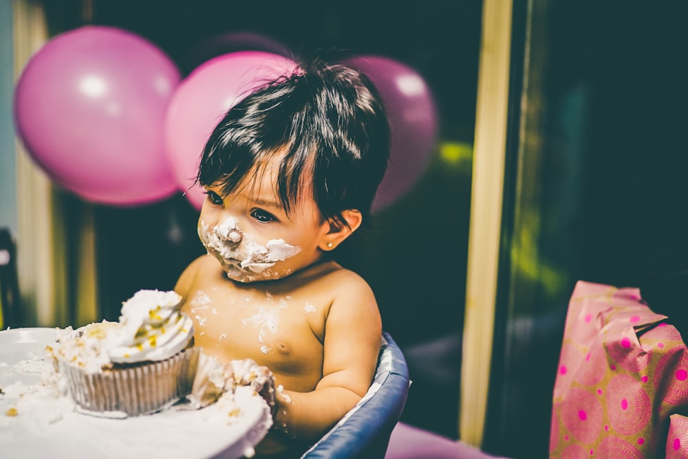 boy sitting on blue highchair