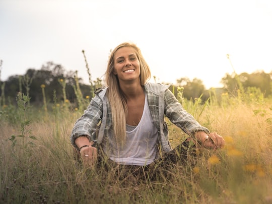 woman sitting on grass field in Grapevine United States