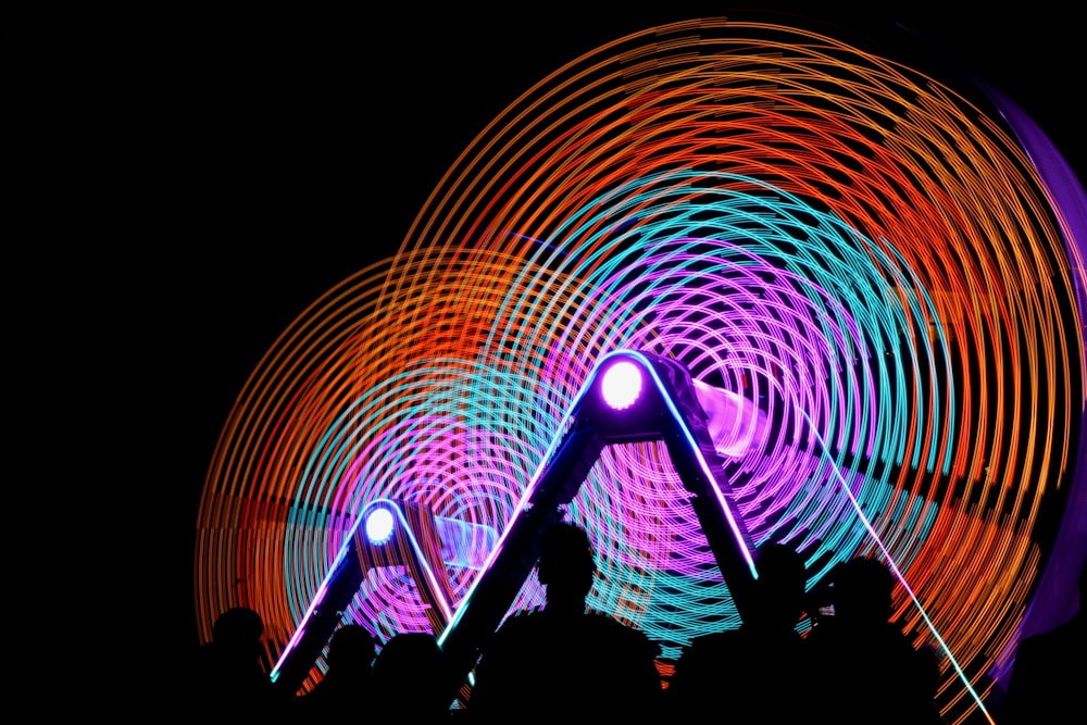 time lapse photography of people gathering infront of ferris wheel