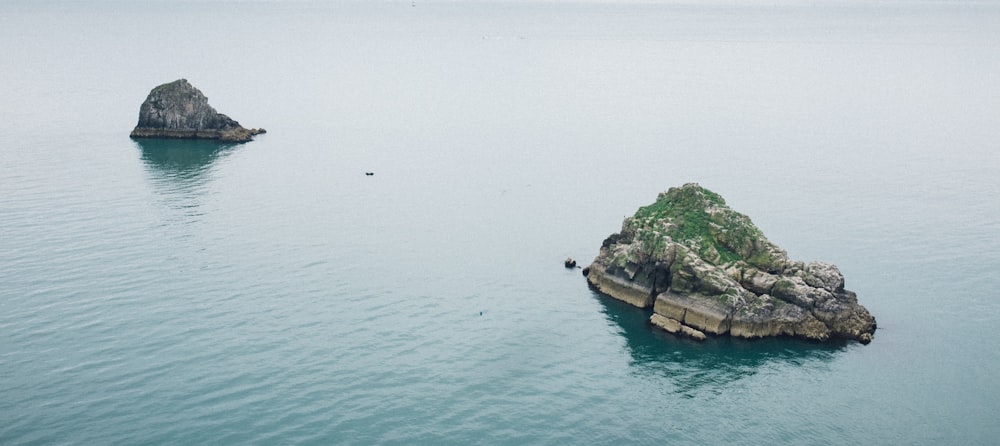 rock formation on body of water scenery