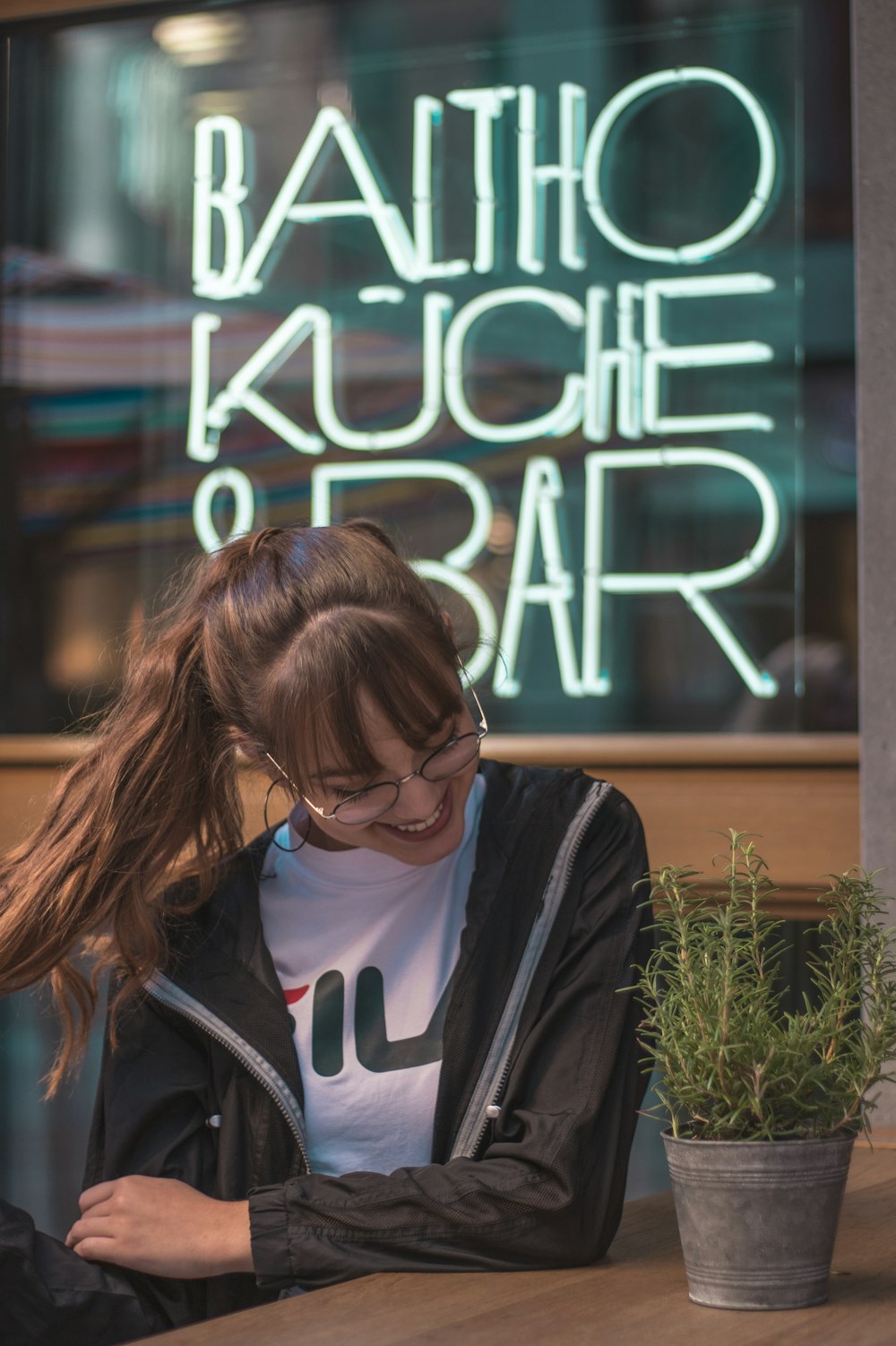 woman sitting outside Baltho Kuche and Bar during daytime