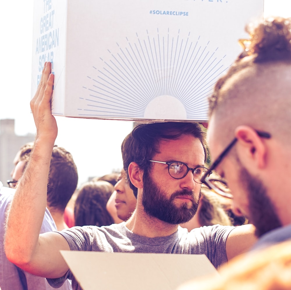 person carrying white and blue box