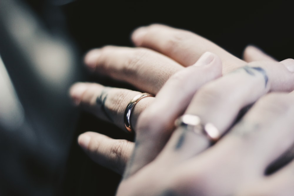 person showing two gold-colored rings