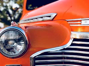 Before and after shots of a restored classic car with polished chrome details