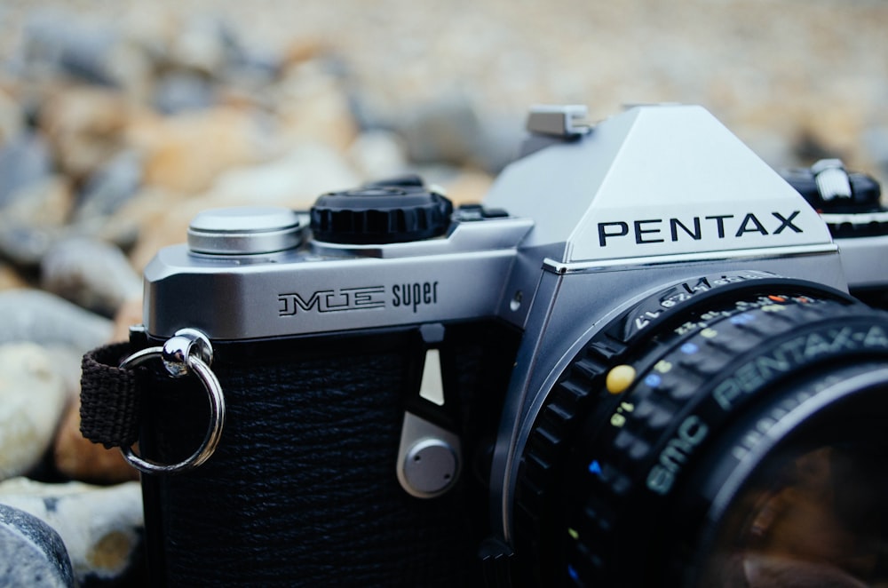 black and silver Pentax SLR camera