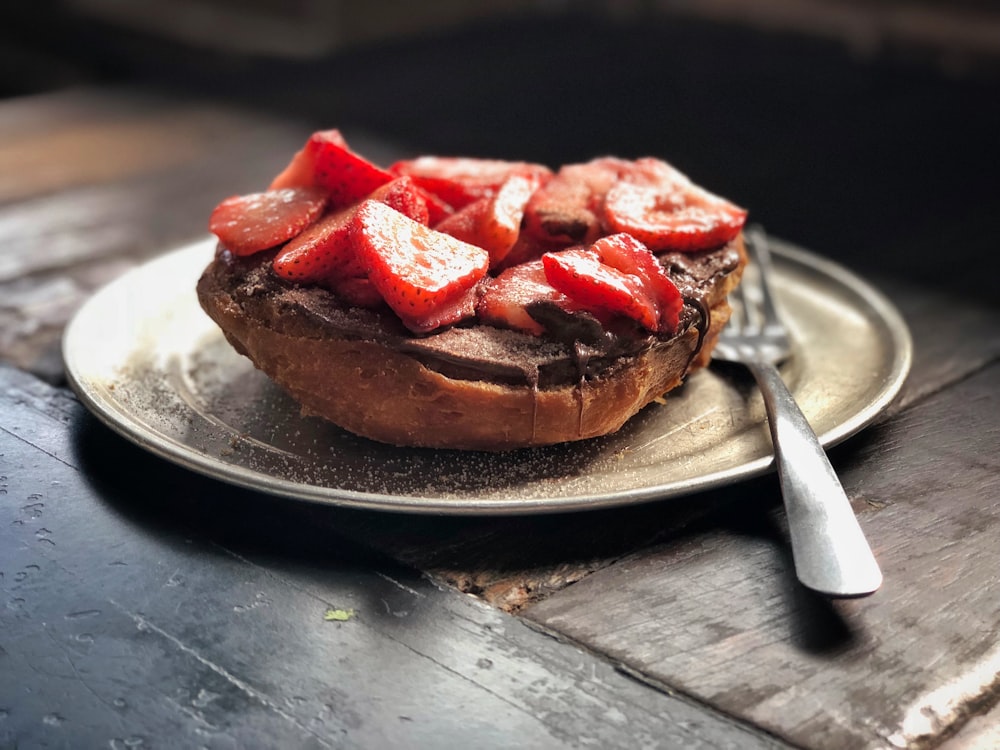 Fotografía de enfoque selectivo de plato de pan con rebanada de fresas