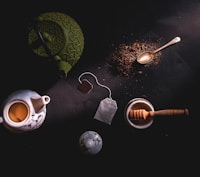two teapots beside mortar and pestle