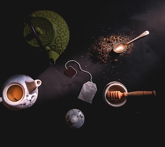 two teapots beside mortar and pestle