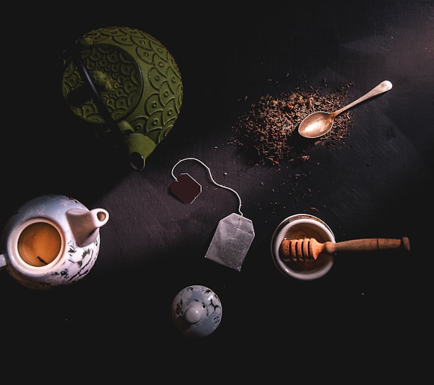 two teapots beside mortar and pestle