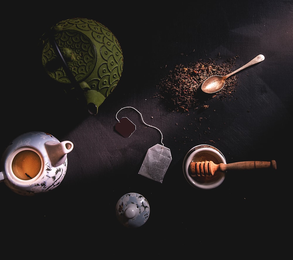 two teapots beside mortar and pestle