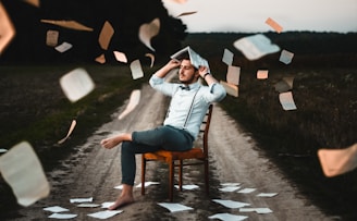 man sitting on chair with book