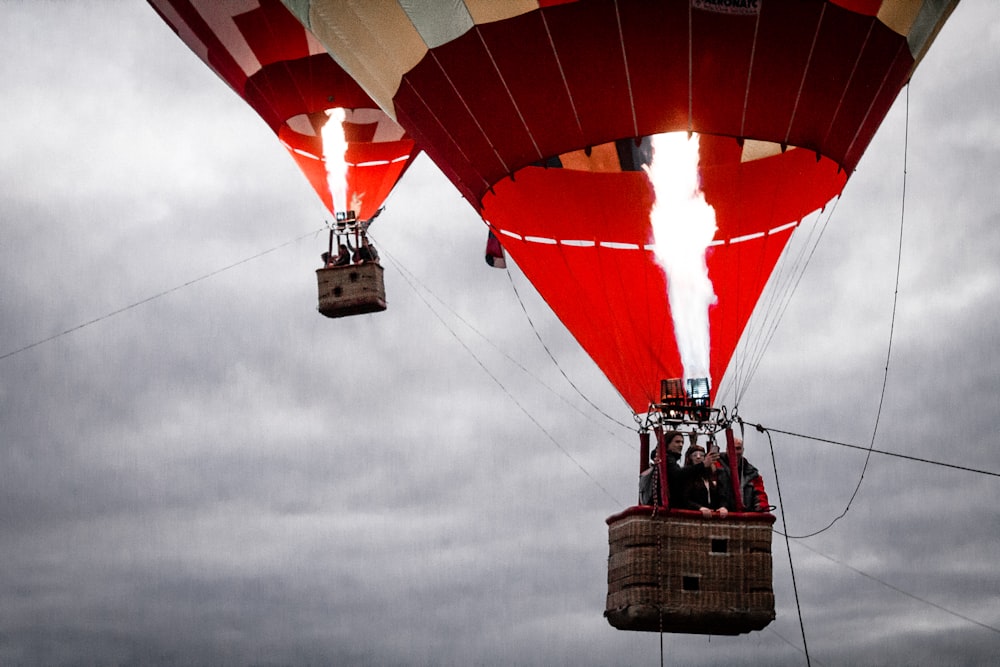 people on red and beige air balloons