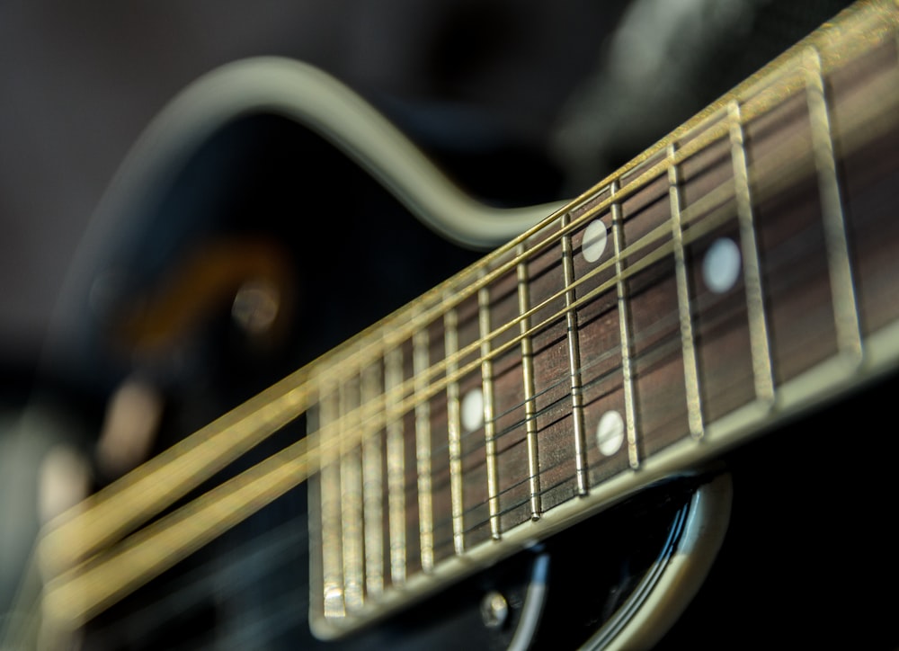 selective focus photography of guitar