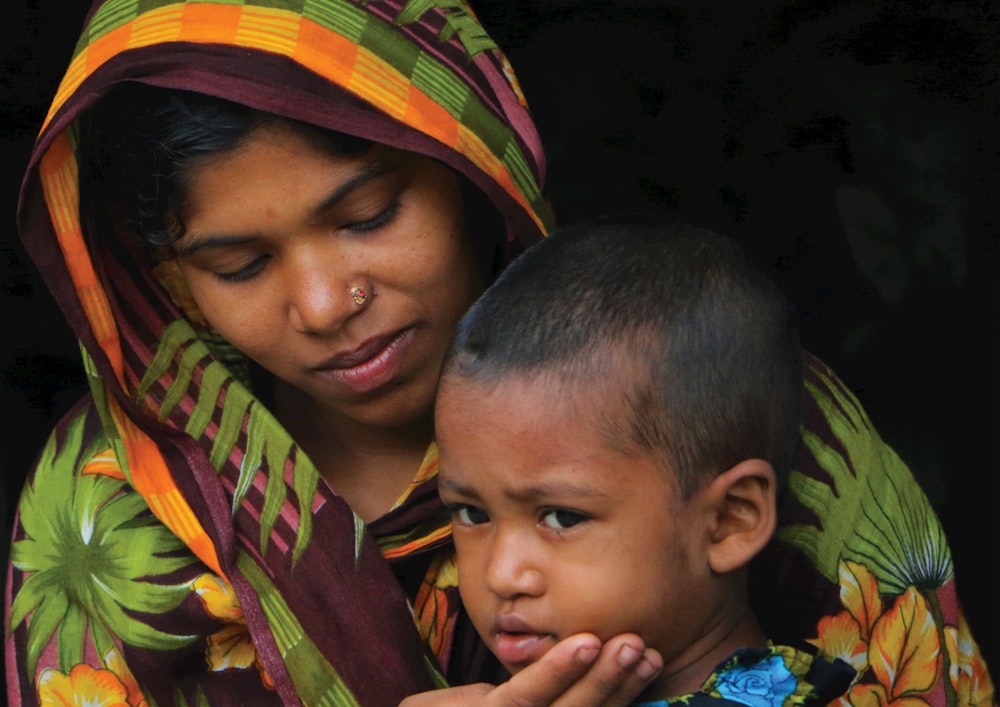 a woman holding a child in her arms