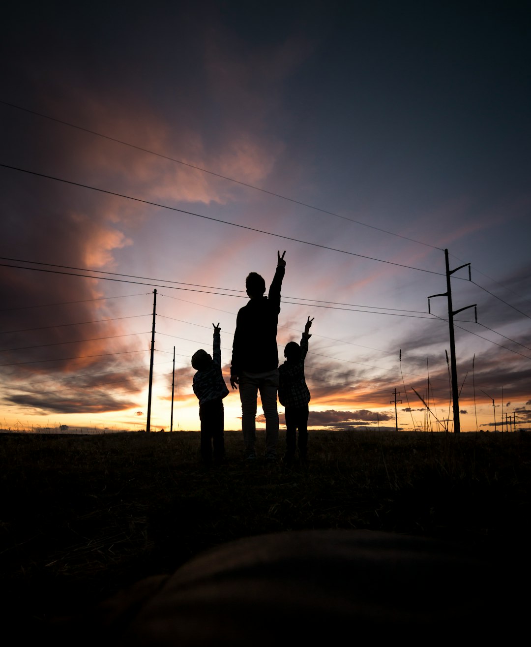 silhouette of three person during daytime