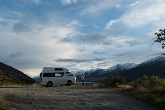 person standing in front of a white van in Lake Wanaka New Zealand
