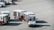 A small airport vehicle is pulling several baggage carts on the tarmac. The number BT 897 is visible on the vehicle, and each cart is labeled with different numbers. The setting appears to be an airport runway area with red lines marking the concrete ground.
